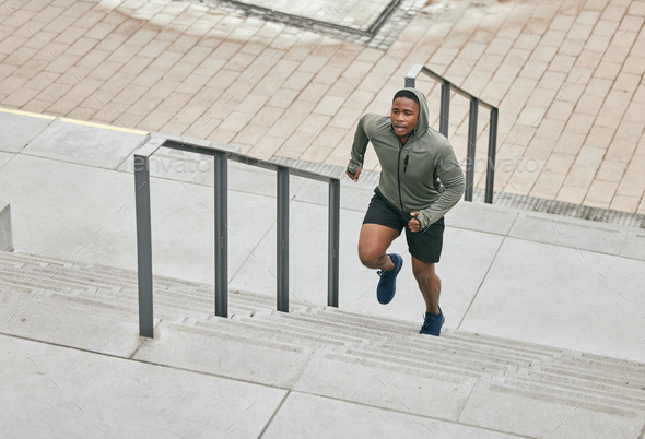 Runner, fitness and city stairs with a sports black man in the city for a cardio or endurance worko