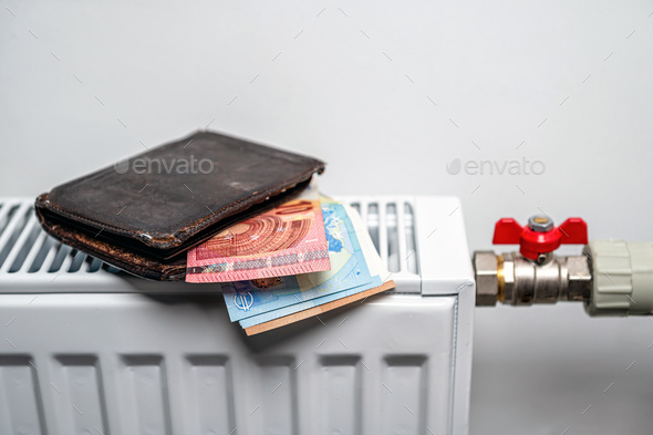 wallet with euro banknotes on central heating radiator, concept of expensive heating costs, closeup - Stock Photo - Images