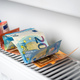euro banknotes in a central heating radiator, the concept of expensive heating costs, closeup - PhotoDune Item for Sale