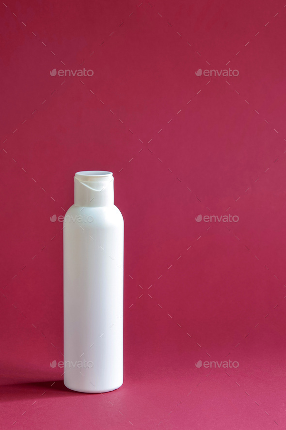 White plastic cosmetic lotion bottle mock-up on purple background.