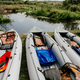 Kayaks ready for rafting are located on the riverbank - PhotoDune Item for Sale