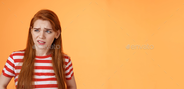 Close-up unsure redhead teenager frowning uncertain, having doubts ...