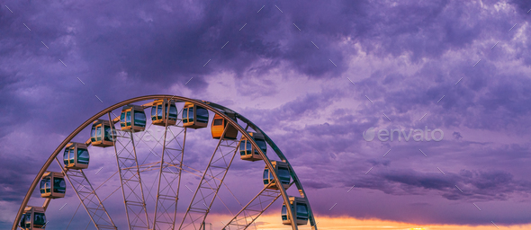 Helsinki, Finland. Very Peri Cloudy Sky Above Ferris Wheel. Light Violet Colors. Bright Dramatic - Stock Photo - Images