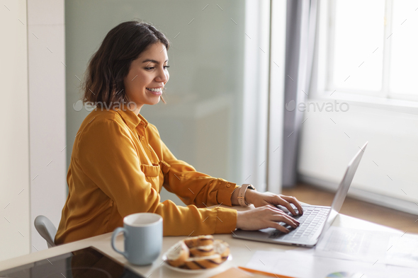 Online Work. Beautiful Young Arab Woman Working With Laptop At Home - Stock Photo - Images