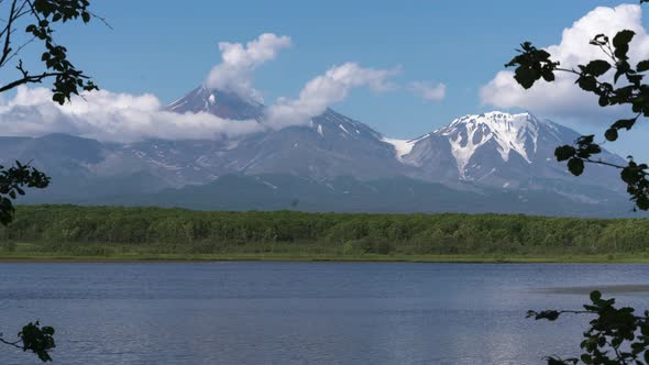 Active Volcano, Clouds Drifting Across Sky, Reflection of Mount in Alpine Lake