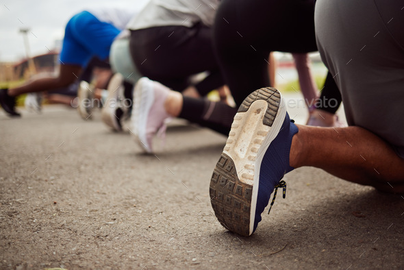 Shoes, fitness or people at the start of a marathon race with performance goals in workout or runne