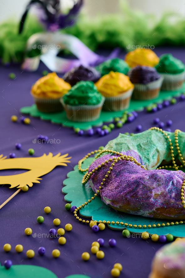 Mardi Gras King Cake with colorful toping and beads.