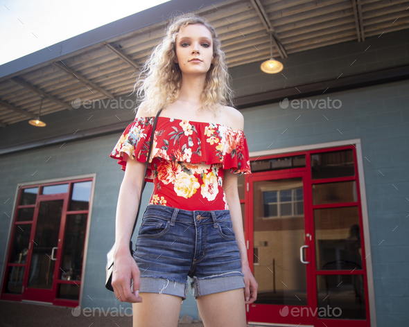 Beautiful blonde female wearing an off shoulder blouse and shorts