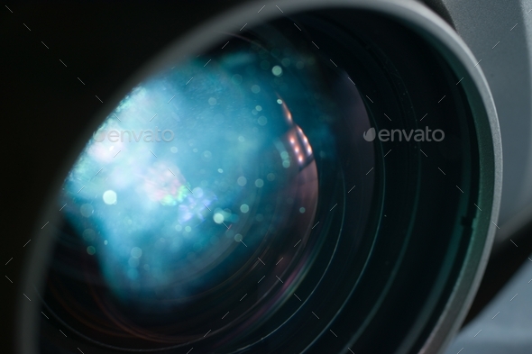 Closeup shot of a projector lens with a blue sparkly reflection-perfect for wallpapers