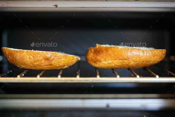 Selective focus shot of the two beagle slices inside of a toaster oven