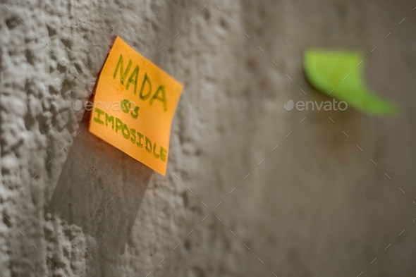 Closeup shot of an orange sticky note with Nothing is impossible written on it
