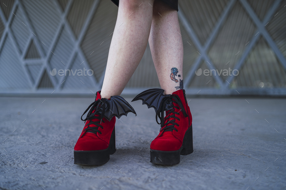 Model wearing the beautiful blood-red high heels with bat wings