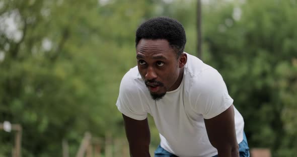 The Black Guy Stopped After Jogging in the Forest Park Tired Exhausted Decided to Rest After