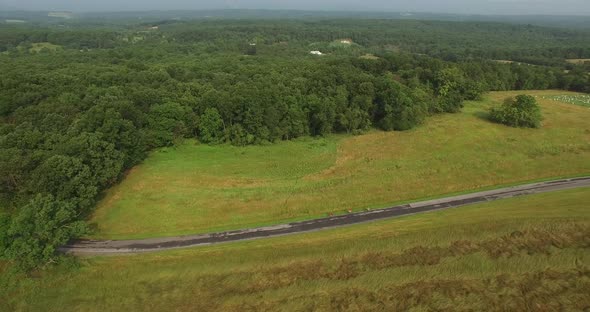 Aerial views of family bicycling along pastoral country roads. alt