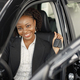 Portrait of black female driver in a car holding a car key - PhotoDune Item for Sale