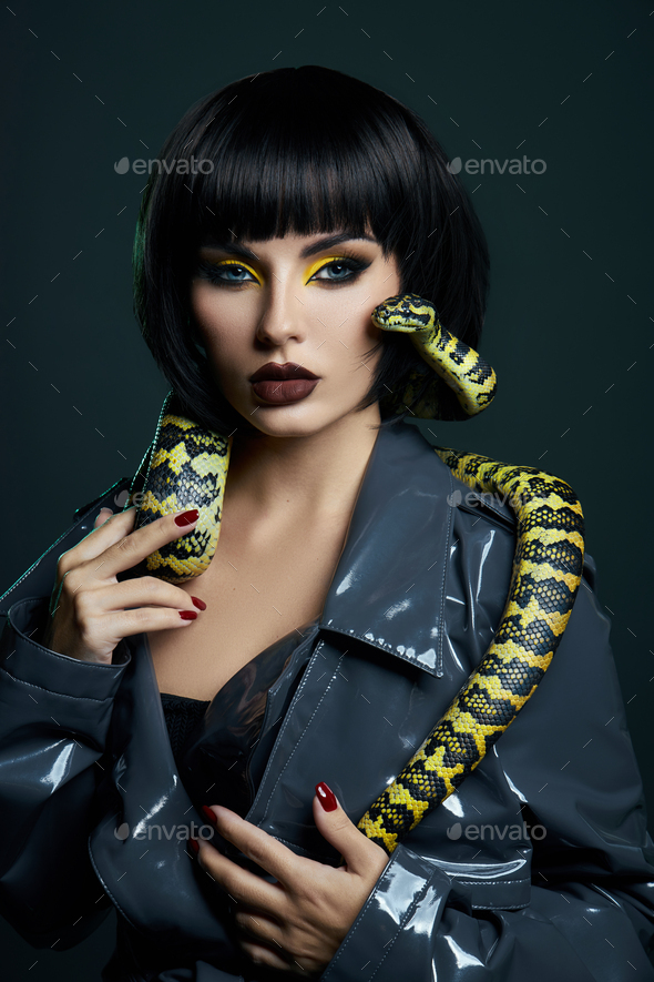 Beauty woman python yellow snake around her neck on latex shiny ...