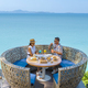 couple having lunch at an restaurant looking out over the ocean of Pattaya Thailand - PhotoDune Item for Sale