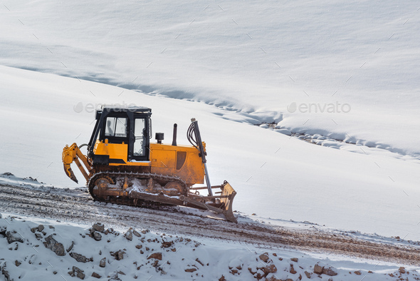 Heavy duty road building machinery bulldozer or earthmover on construction site - Stock Photo - Images