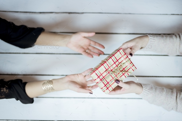 Selective closeup shot of decorated gift boxes wrapped with beige wrapping  paper Stock Photo by wirestock