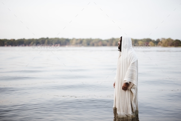 Biblical scene - of Jesus Christ standing in the water with a blurred ...