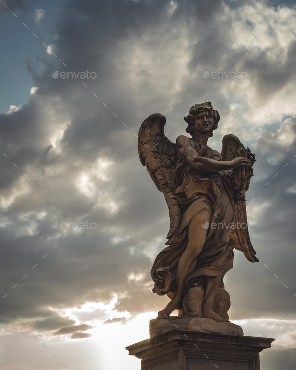 Victorian statue of an angel with an angry facial expression under the dark cloudy sky