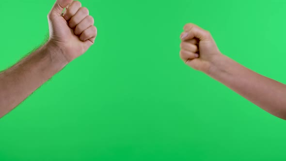 A Woman and a Man Play Rock Paperscissors Several Times Against the Background of the Green Screen alt