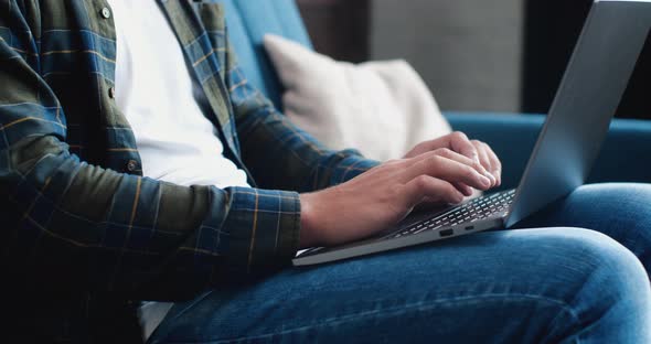 Close Up of Male`s Hands are typing on the Laptop. alt
