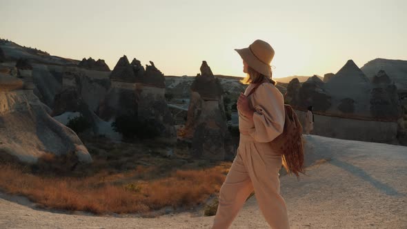 A Beautiful Young Woman Tourist Happy Walking in the Valley of the Monks in Turkey alt