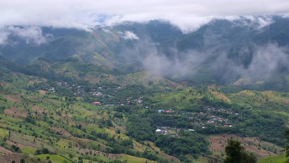 Landscape view of rural village in valley on foggy day