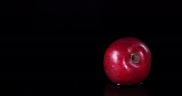 Fresh Red Apple Rotating in Water.  alt