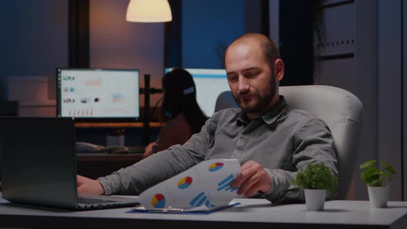 Portrait of Smiling Businessman Sitting at Desk Table Analysing Financial Statistics alt