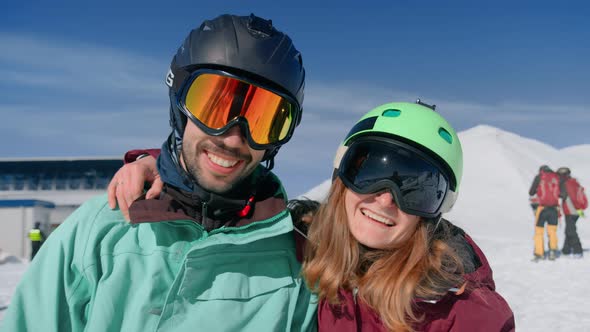 Two Friends in Ski Goggles Pose Smiling for Photos alt