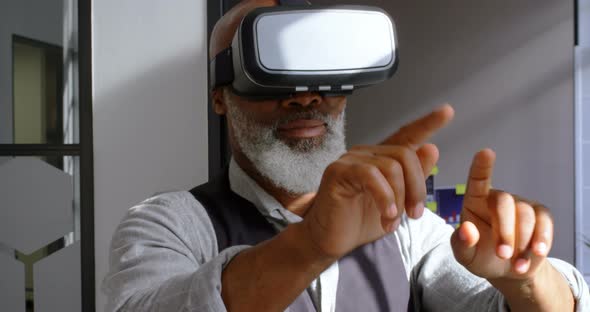 Businessman removing virtual reality headset in the office 4k alt