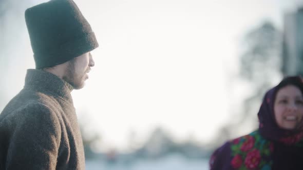 Russian Folklore - Man and Woman in Russian Folk Costumes Are Laughing on the Street alt