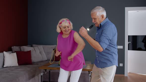 Senior Mature Couple Dancing Together in Room at Home During Quarantine Lockdown for Coronavirus alt