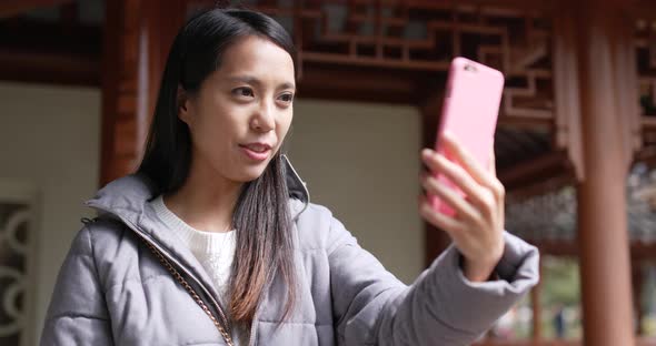 Asian woman use of mobile phone alt