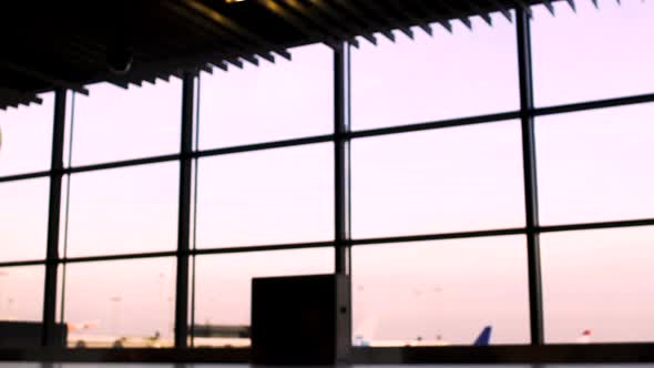 Silhouettes of Business People Walking in Airport, Plane Takeoff on Background alt