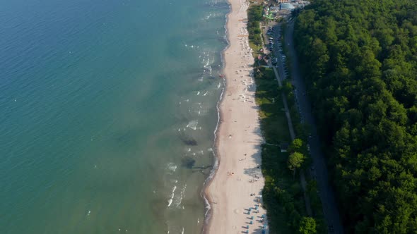 Amazing Aerial Drone Flying Above Tourist Baltic Sea Beach in Scharbeutz Germany Dolly in Day alt
