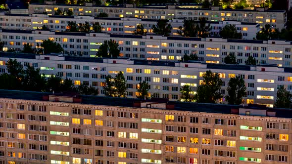 Timelapse of Residential Quarters of the Night City with the Lights on From the Windows of the alt