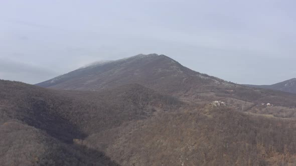 Slow flying over the landscape with Veliki Krs mountain 4K drone footage alt