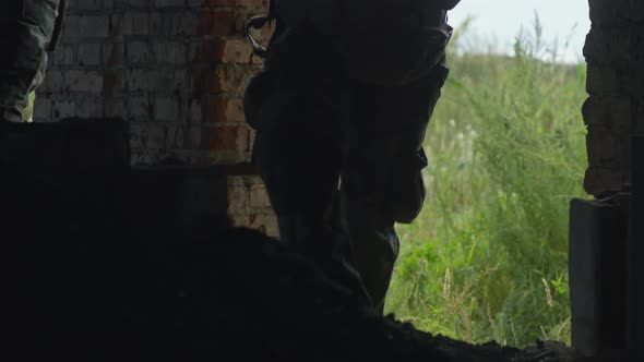 Group of Armed Soldiers Entering Ruined House alt