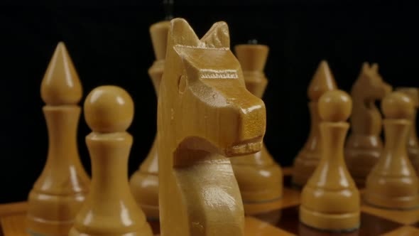 Men's Hand Puts a Knight on Checkerboard Cell alt