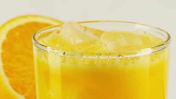 Carbonated Orange Soft Drink with Ice in a Glass alt