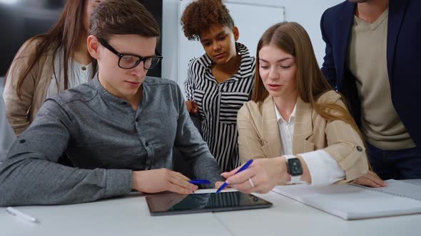 Team of Young Managers Discussing New Project at Meeting alt