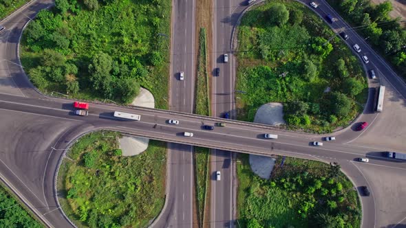 Traffic Driving Over Roundabout with Highway Road Underneath alt