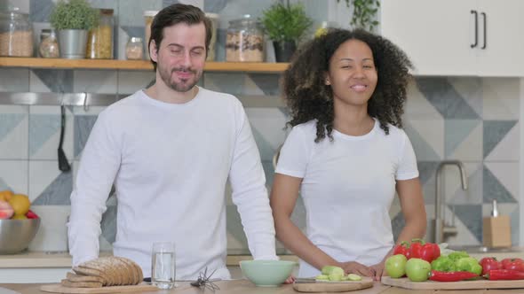 Mixed Race Couple Showing Yes Sign in Kitchen Head Shake alt