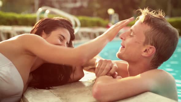 Beautiful Young Romantic Couple Have Fun at the Poolside in Summer Day