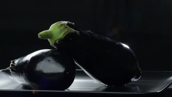 Natural Eggplants on Black Background alt