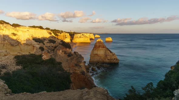 Beautiful sunset timelapse of rock formations on the coast near Benagil, Algarve, Portugal alt