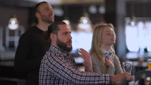 Happy Friends Singing National Anthem Watching Sport Match in Pub Drinking Beer alt